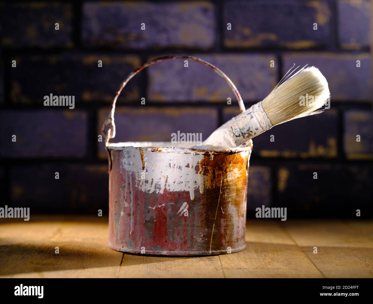 Paint tin bucket splattered with red and white paint with old paint