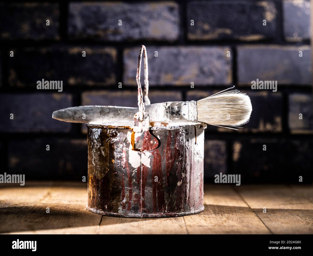 Paint tin bucket splattered with red and white paint with old paint