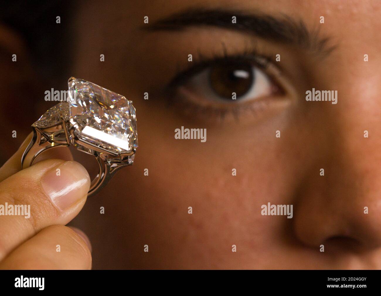 A Christie's employee displays the Annenberg Diamond during a presentation  in Geneva September 14, 2009. The square emerald-cut D colour, Flawless  diamond of 32.01carats, mounted as a ring and flanked by two