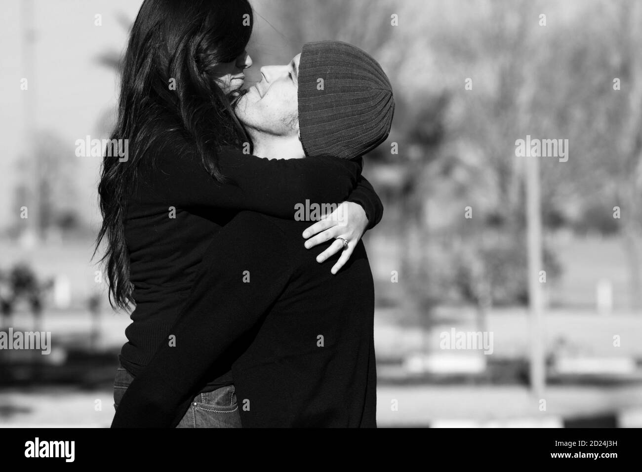 A couple embrace on a sunny winter day Stock Photo