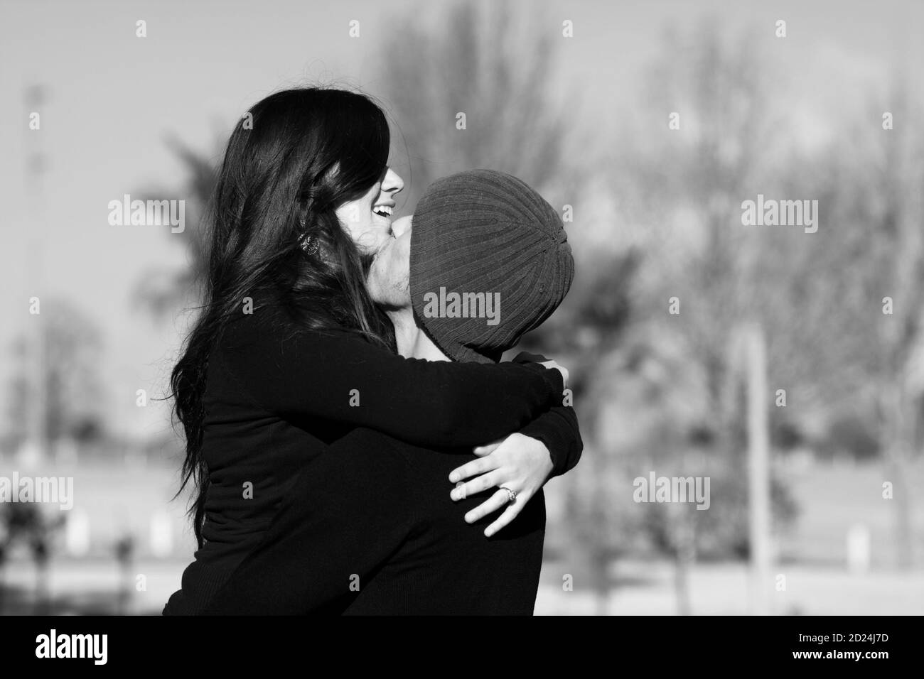 A couple embrace on a sunny winter day Stock Photo