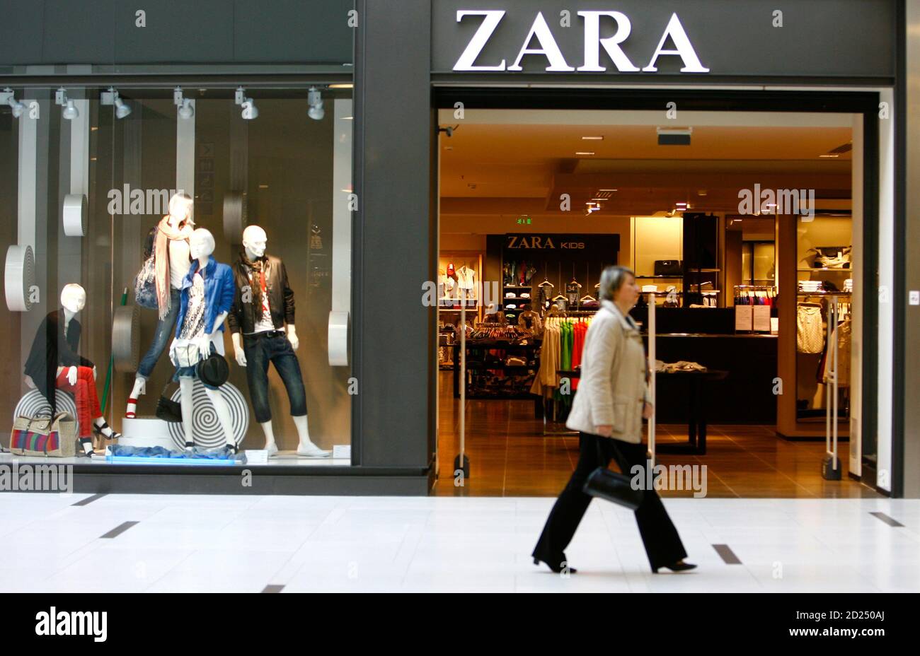 A woman walks pass a Zara shop in the newly-opened Riga Plaza shopping  center in Riga April 8, 2009. The latest data released on Monday by EU  statistics agency Eurostat show that