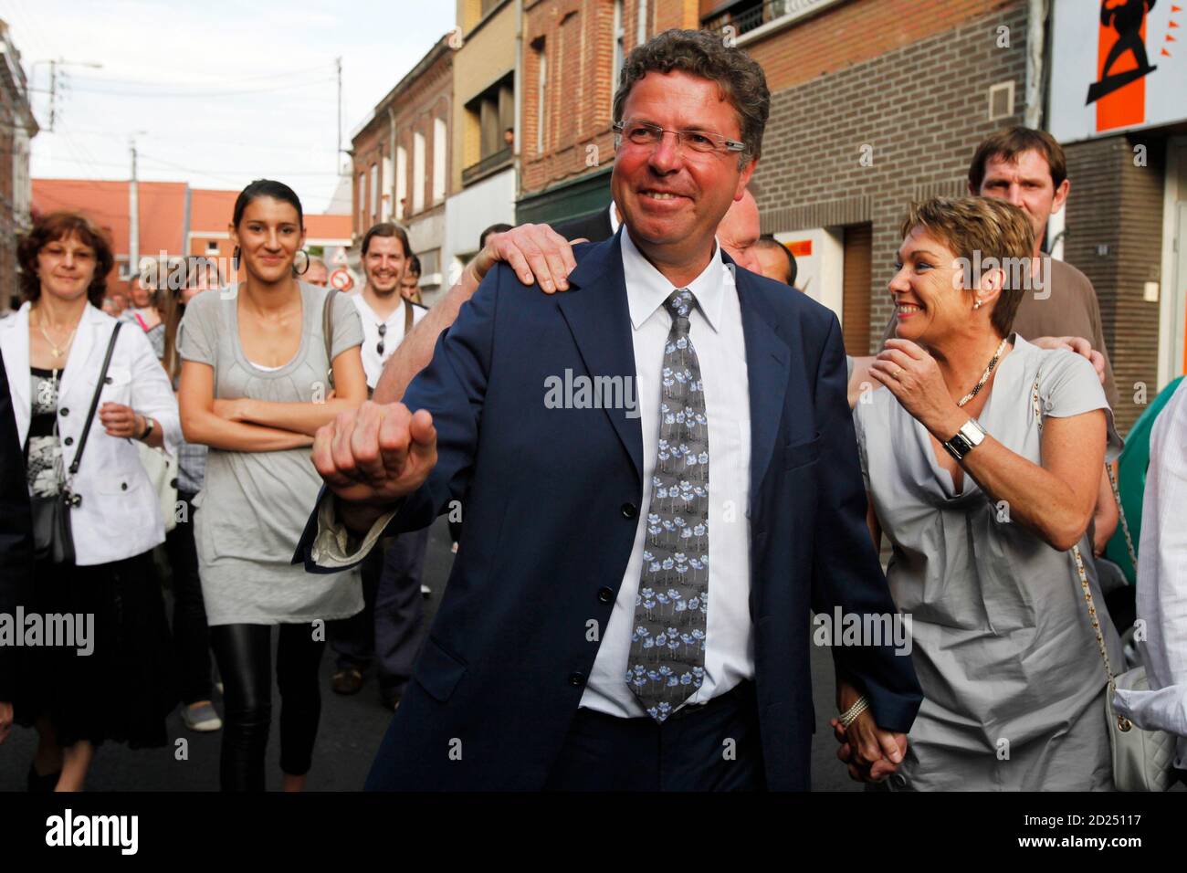 Daniel Duquenne celebrates defeating National Front's Marine Le Pen,  daughter of party leader Jean-Marie Le Pen, in the second round of local  elections, in the streets of Henin Beaumont July 5, 2009.