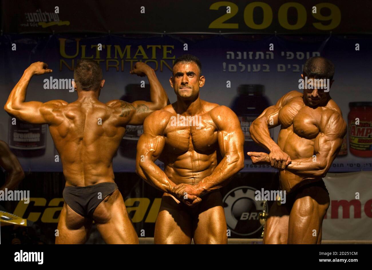 Walid Nasser a din (C) poses before winning the Mr. Israel bodybuilding  contest in Haifa August 27, 2009. About 60 Israeli men competed on Thursday  in the annual contest sponsored by the