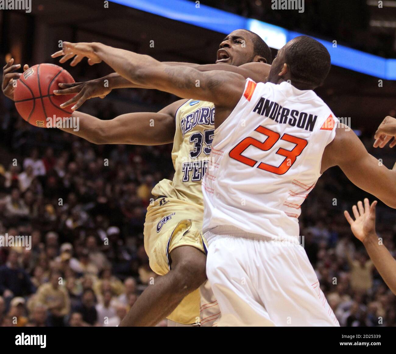 Georgia Tech forward Zachery Peacock is fouled by Oklahoma State guard  James Anderson (R) as he attempts to shoot in the first half of their NCAA  Division I Men's Basketball Tournament game