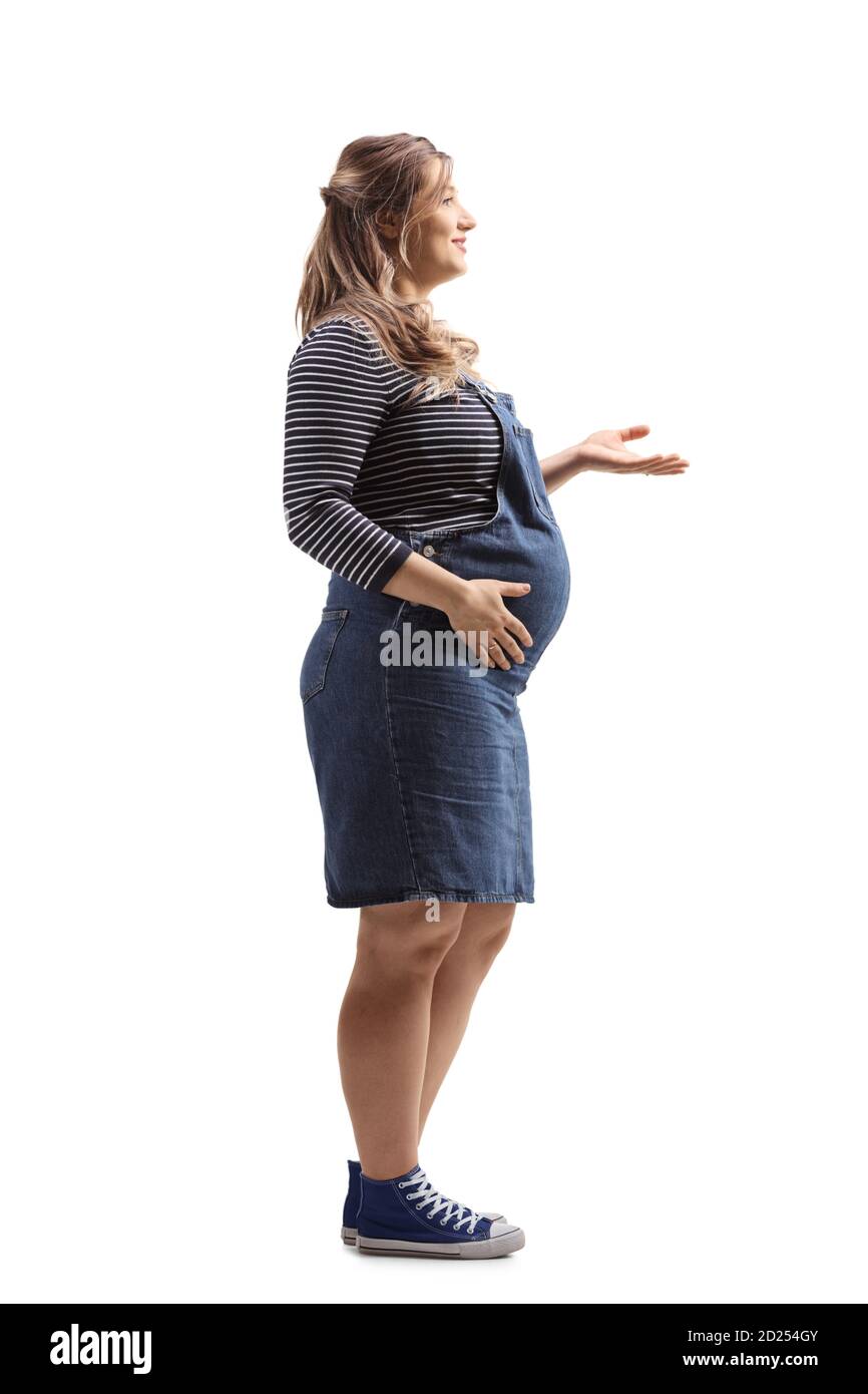 Full length profile shot of a young pregnant woman gesturing with hand isolated on white background Stock Photo