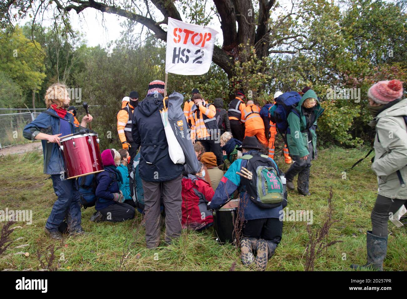 Warwickshire, UK. 05th Oct, 2020. HS2 protestors break through baricades to draw attention to the destruction of a 250 year old, tree of the year 2015, the Cubbington Pear tree 05 Oct 2020. As protestors approach the tree they are met with extreme force from HS2 security guards in order to prevent them from hugging the tree Credit: Denise Laura Baker/Alamy Live News Stock Photo