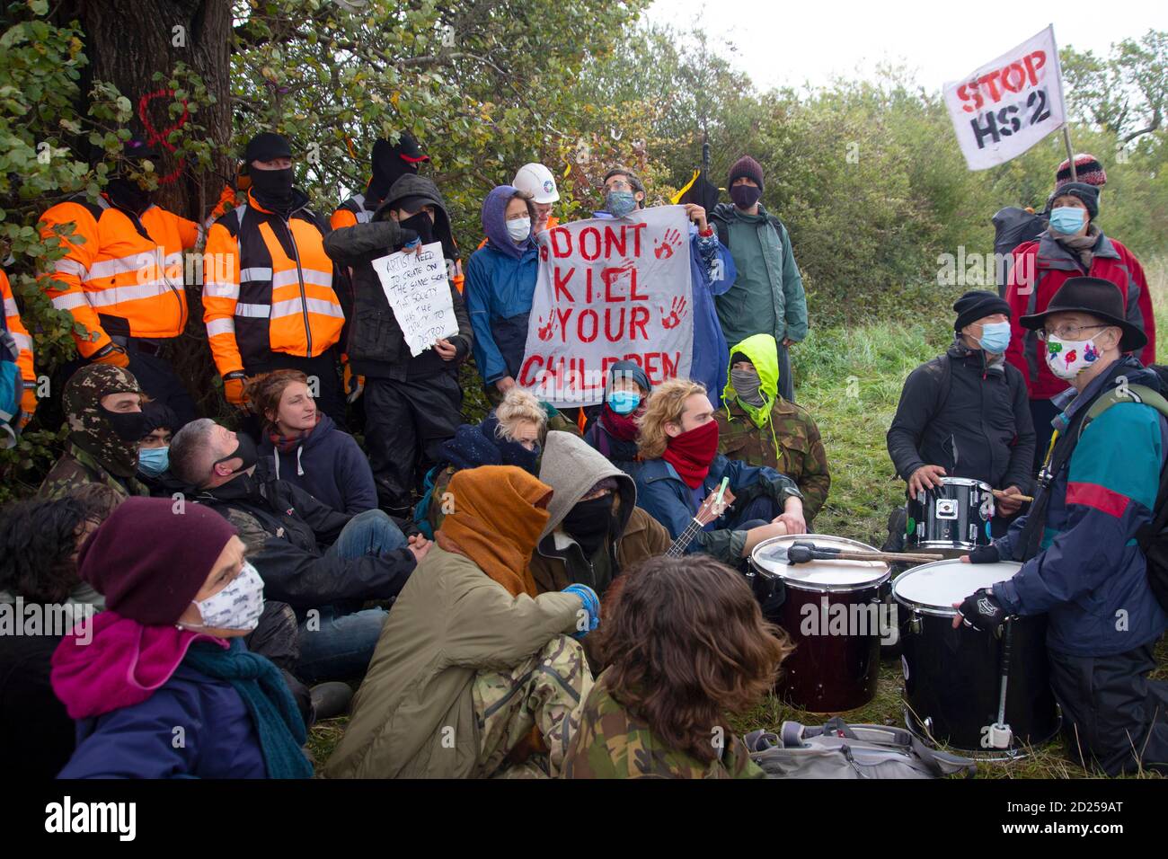 Warwickshire, UK. 05th Oct, 2020. HS2 protestors break through baricades to draw attention to the destruction of a 250 year old, tree of the year 2015, the Cubbington Pear tree 05 Oct 2020. Protestors sit at the feet of HS2 security guards holding a peaceful vigil while security stand in front of the pear tree blacking the protestors from getting near it Credit: Denise Laura Baker/Alamy Live News Stock Photo