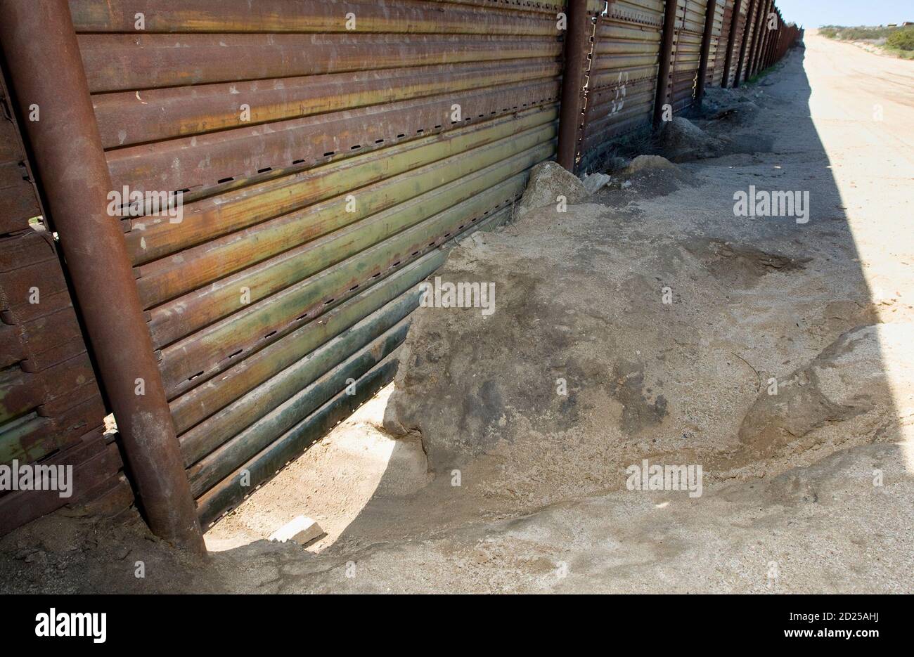 A man-sized hole dug under the border fence that separates the US and Mexico  along the border sits un-repaired near Campo, California in this photo  taken March 17, 2008. As U.S. authorities