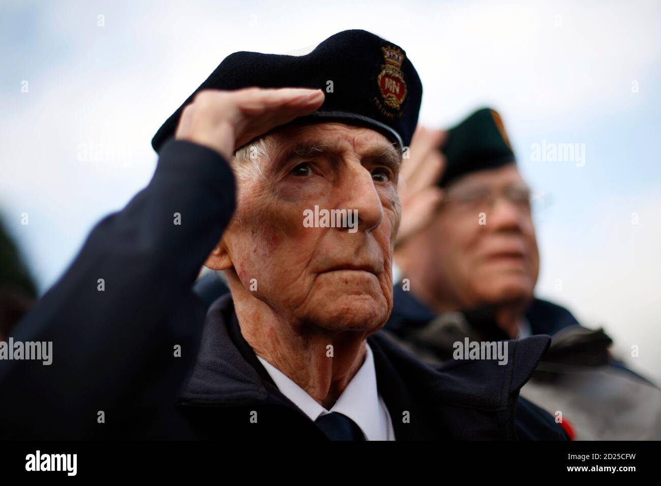 Canadian Second World War veterans Phil Etter (L) and Bill Story salute during a Remembrance Ceremony at the Mons Cemetery in Mons, Belgium November 11, 2008. A group of Canadian veterans is travelling through France and Belgium to commemorate the 90th anniversary of the end of the First World War.       REUTERS/Chris Wattie       (BELGIUM) Stock Photo