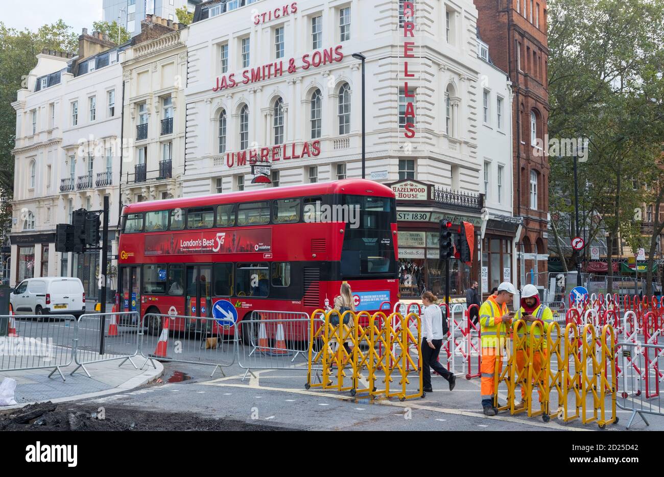Workmen on their phones, New Oxford Street, London Stock Photo