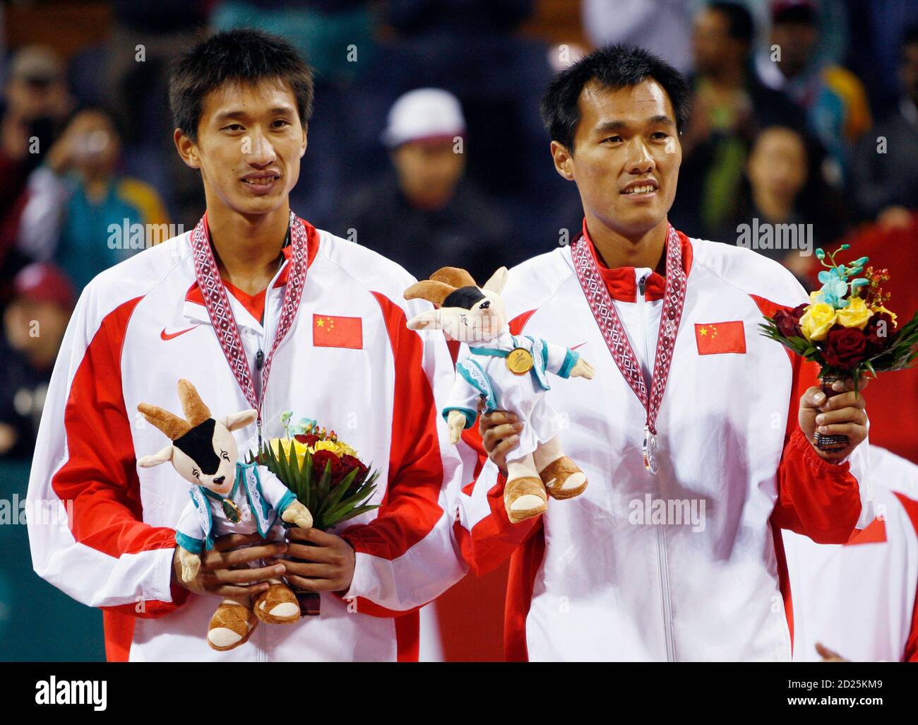 Silver Medal winners Wu Penggen and Xu Linyin (L) of China pose with their  medals after the beach volleyball finals during the 15th Asian Games in  Doha December 11, 2006. REUTERS/Fadi Alassaad (