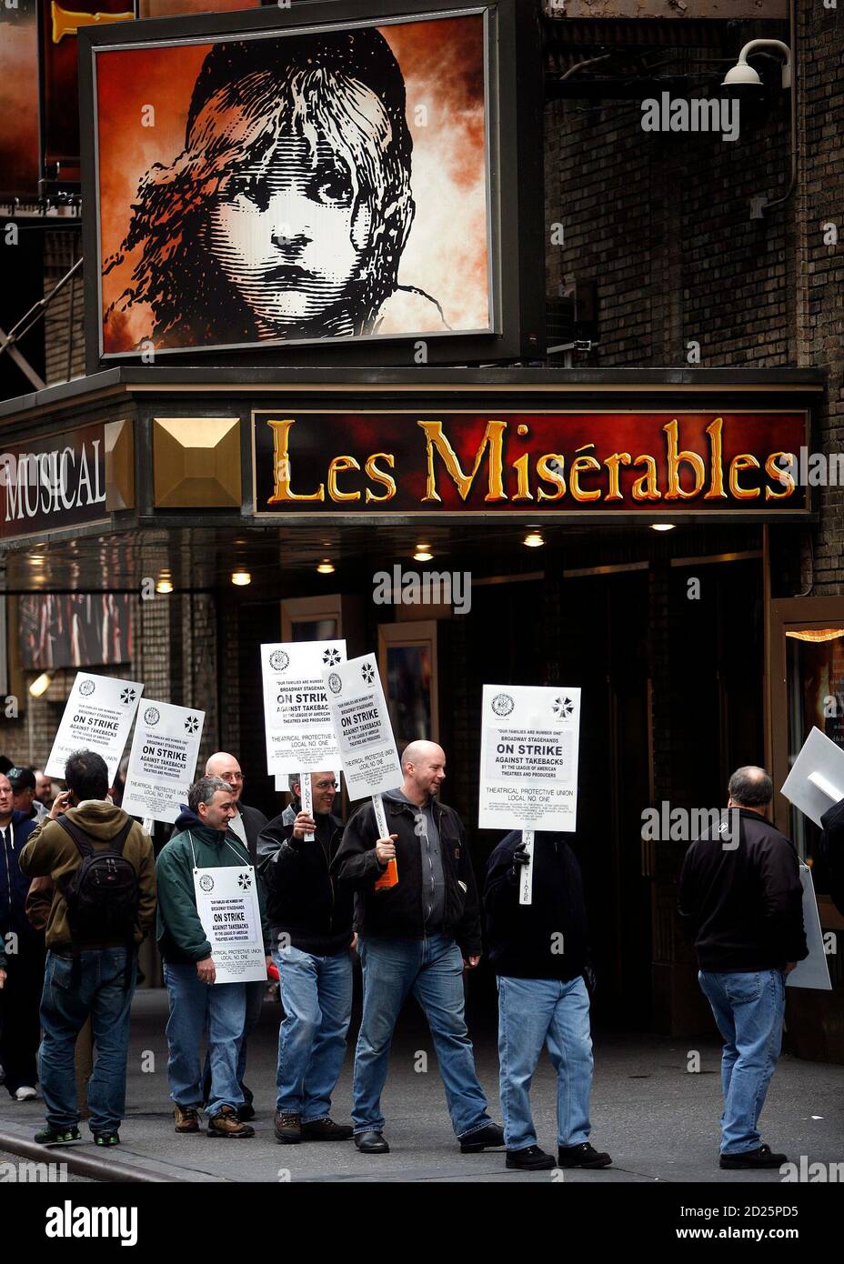 Members of the stagehands union walk the picket line in front of the  Broadway show 