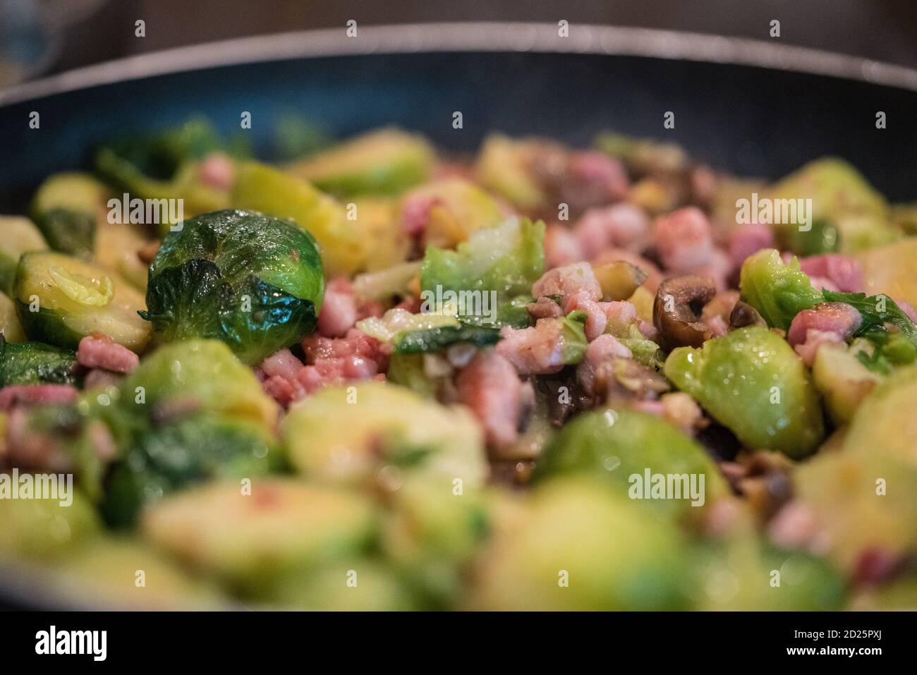 Brussel sprouts, chestnuts and bacon being panfried Stock Photo Alamy
