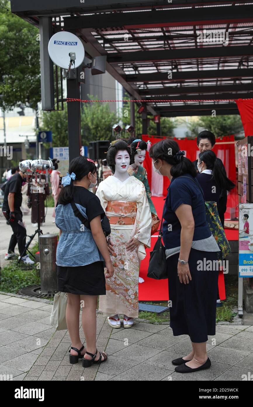 Hachioji, Tokyo, Japan. 3rd Oct, 2020. A Geisha talks to her Fans after the first public stage a performance since quarantine.Hachioji city has just a few Okiya houses (houses where Geishas live and learn their art). Geichas made their first performance on the public stage on 3th October after quarantine. Musician entertainers were separated from each other by a plastic screen as a precaution measure against Covid-19. Credit: Marina Takimoto/SOPA Images/ZUMA Wire/Alamy Live News Stock Photo