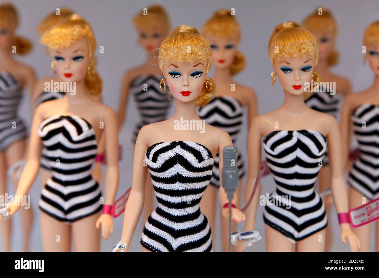 Barbie dolls sit on a display before the Barbie house opening ceremony in  Shanghai March 6, 2009. Mattel Inc will roll out new services to  reinvigorate its 50-year-old Barbie brand, such as
