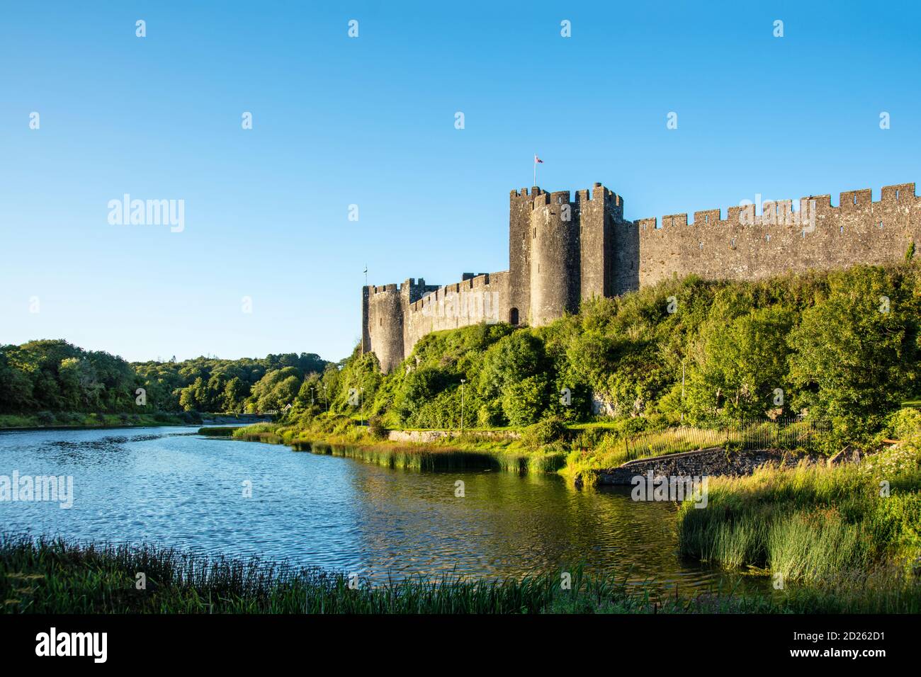 The privately owned Pembroke Castle and lake on the Milford Haven Waterway, Wales, UK Stock Photo
