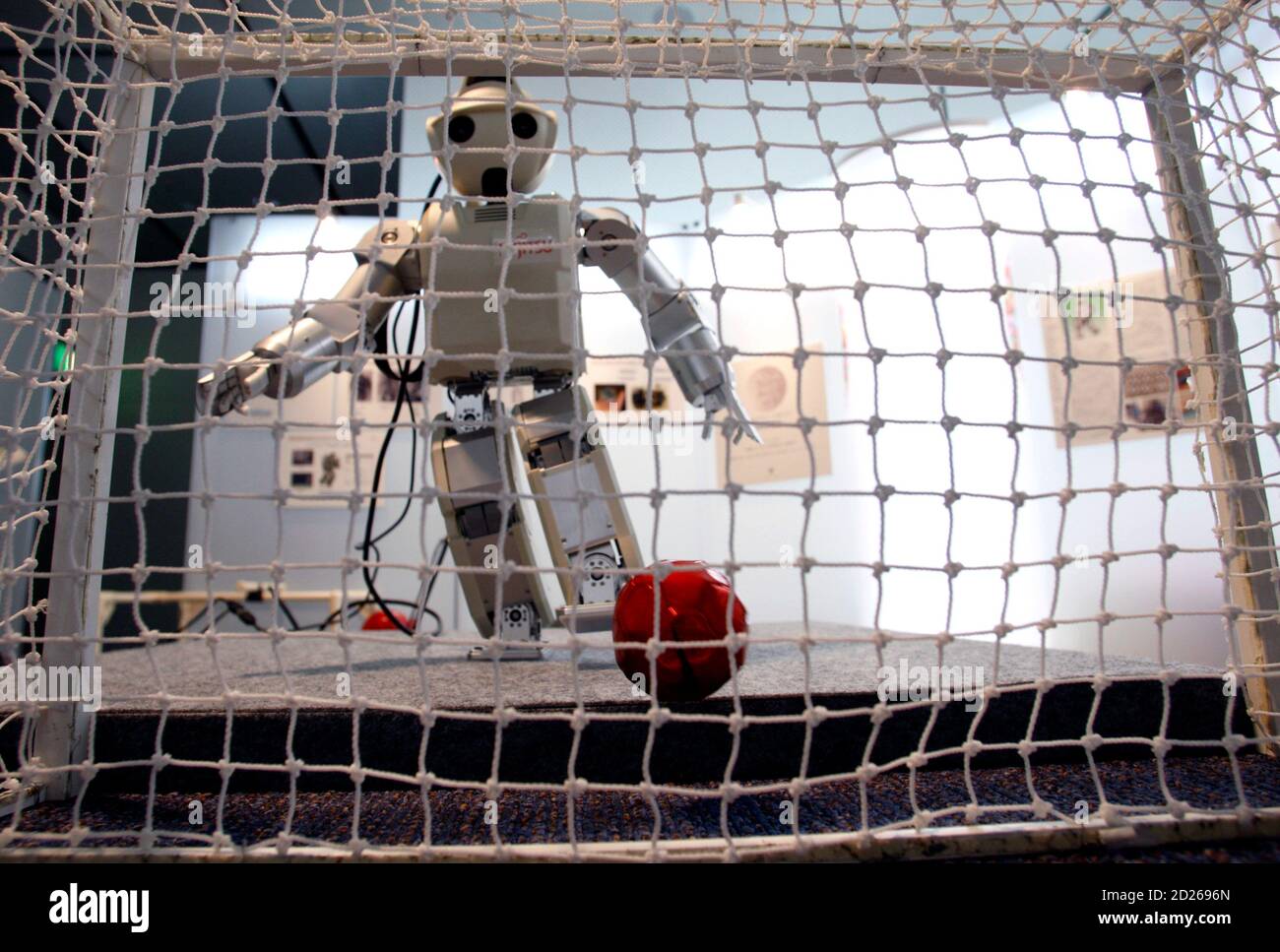 Fujitsu Automation's miniature humanoid robot HOAP-3 kicks a ball during  the Robot award 2007 in Tokyo December 20, 2007. HOAP-3 is able to track  and grab a small ball with image recognition