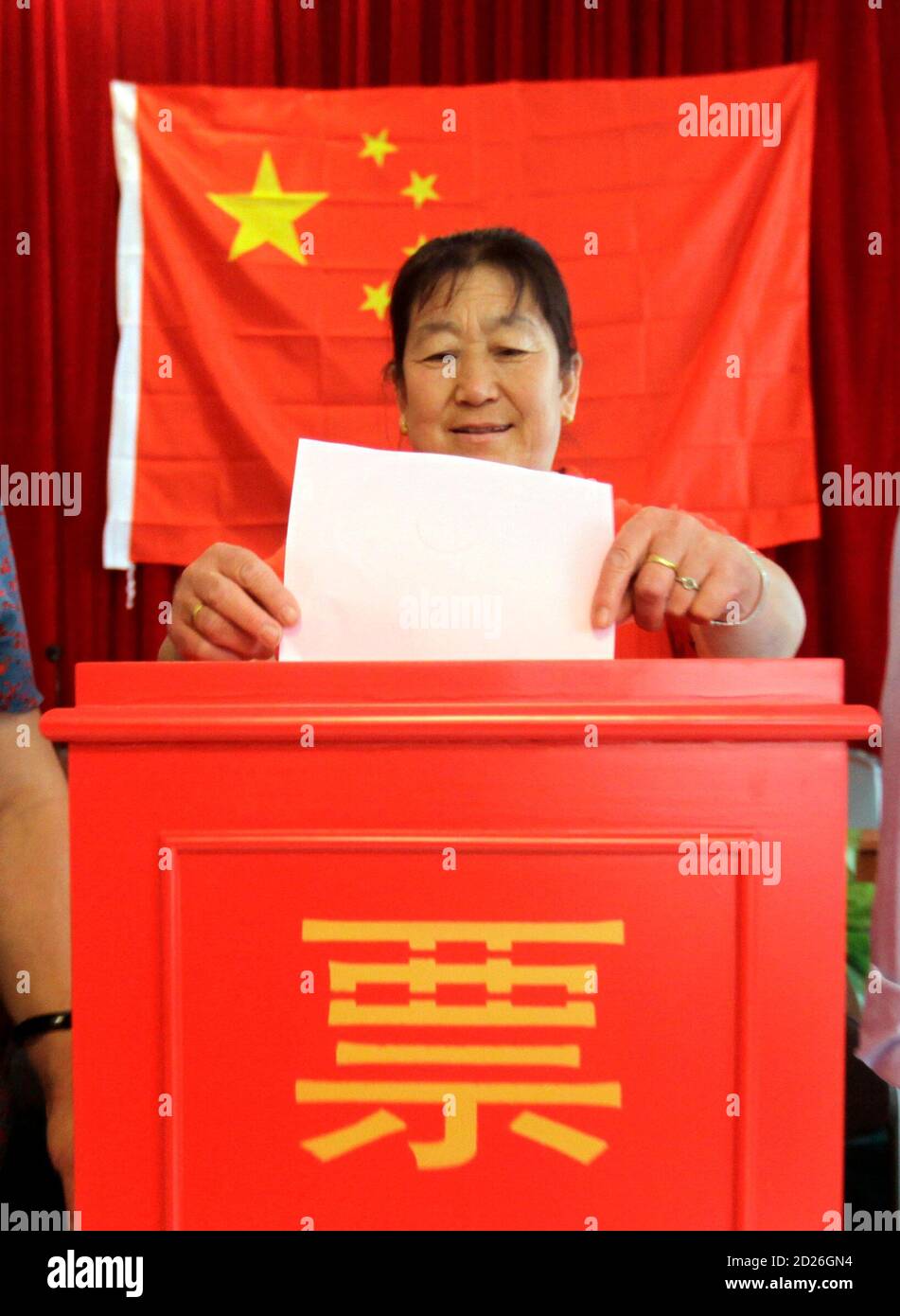 A villager casts a vote during a local election of the villagers' committee at Xiwangping Village in Beijing's Mentougou District June 18, 2010. REUTERS/Jason Lee (CHINA - Tags: POLITICS ELECTIONS) Stock Photo