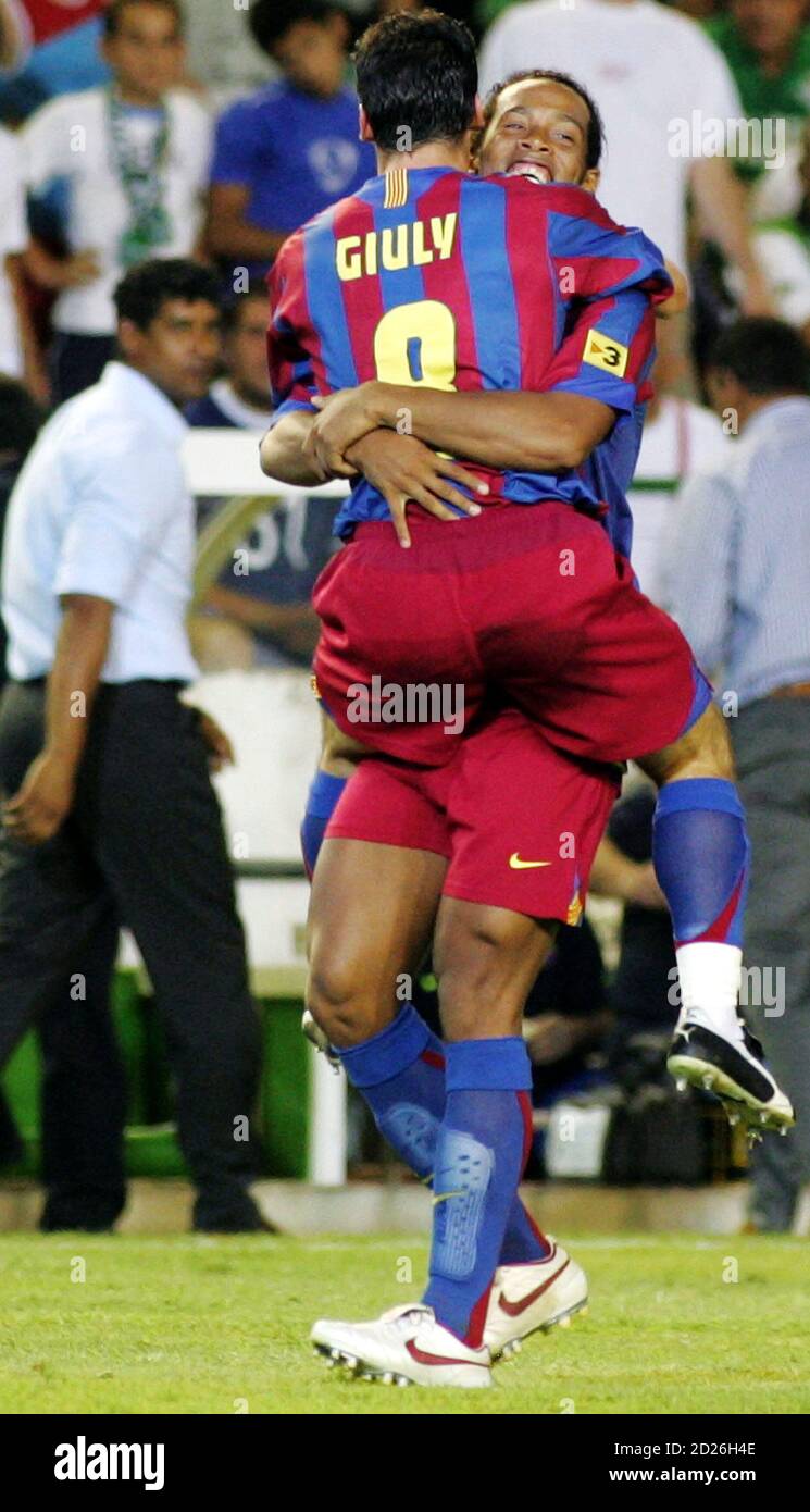Barcelona's Ronaldinho embraces team mate Ludovic Giuly after Giuly scored  during the first leg of their Spanish Super Cup soccer match against Real  Betis in Seville August 13, 2005. After ending a