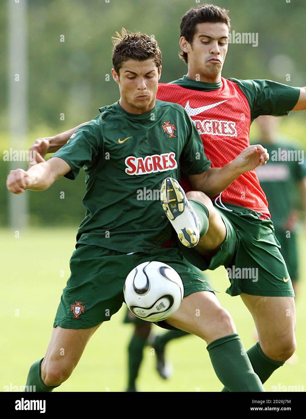 PHOTO TAKEN 07JUN06- Portugal's national soccer player Cristiano Ronaldo  (L) and Ricardo Costa (R), both wearing Nike apparel, battle for the ball  during a training session in Marienfeld, northwest Germany, June 7,