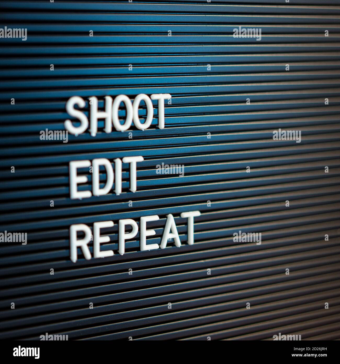 Letterboard sign saying Shoot, Edit, Repeat Stock Photo
