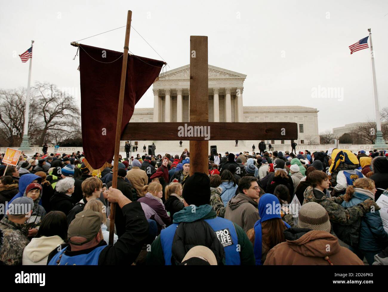 A pro-life demonstrator holds a cross up in front of the U.S. Supreme Court during the 'March for Life', marking the 35th anniversary of the Supreme Court's 1973 decision in Roe vs Wade that made abortion legal, in Washington January 22, 2008.    REUTERS/Kevin Lamarque   (UNITED STATES) Stock Photo
