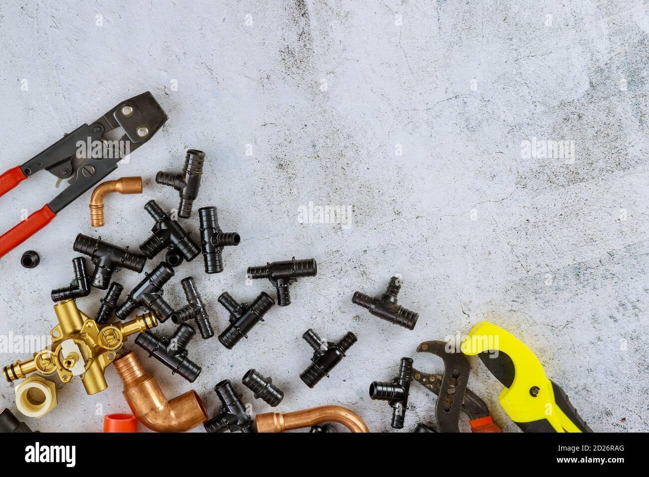 Polypropylene pipes, pipe cutting tools, adapters, work gloves in the