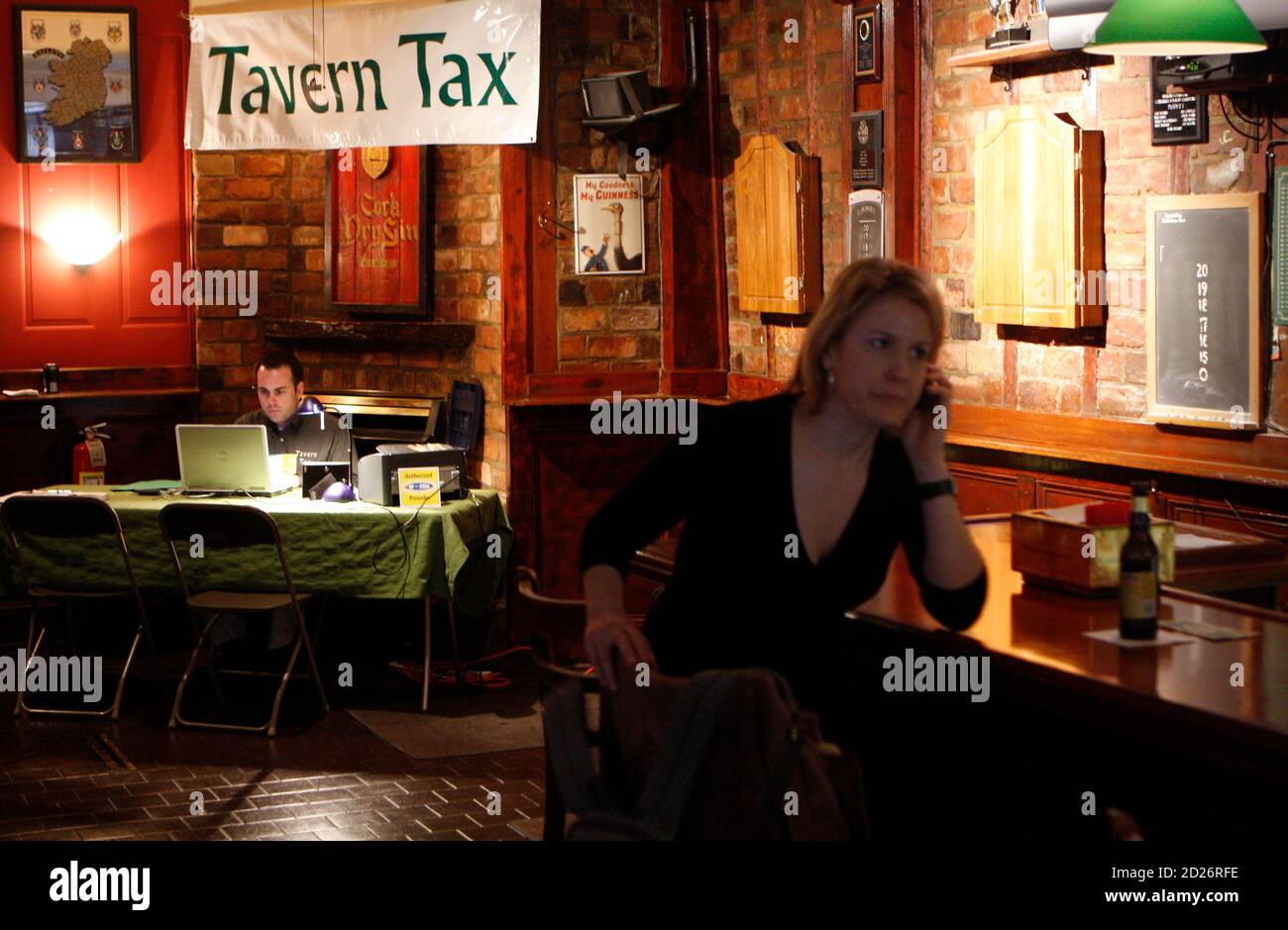 Carmine Sodora of Tavern Tax waits for his clients to arrive at his  makeshift income tax office as a woman sits at the bar at Duffy's tavern in  Hoboken, New Jersey April