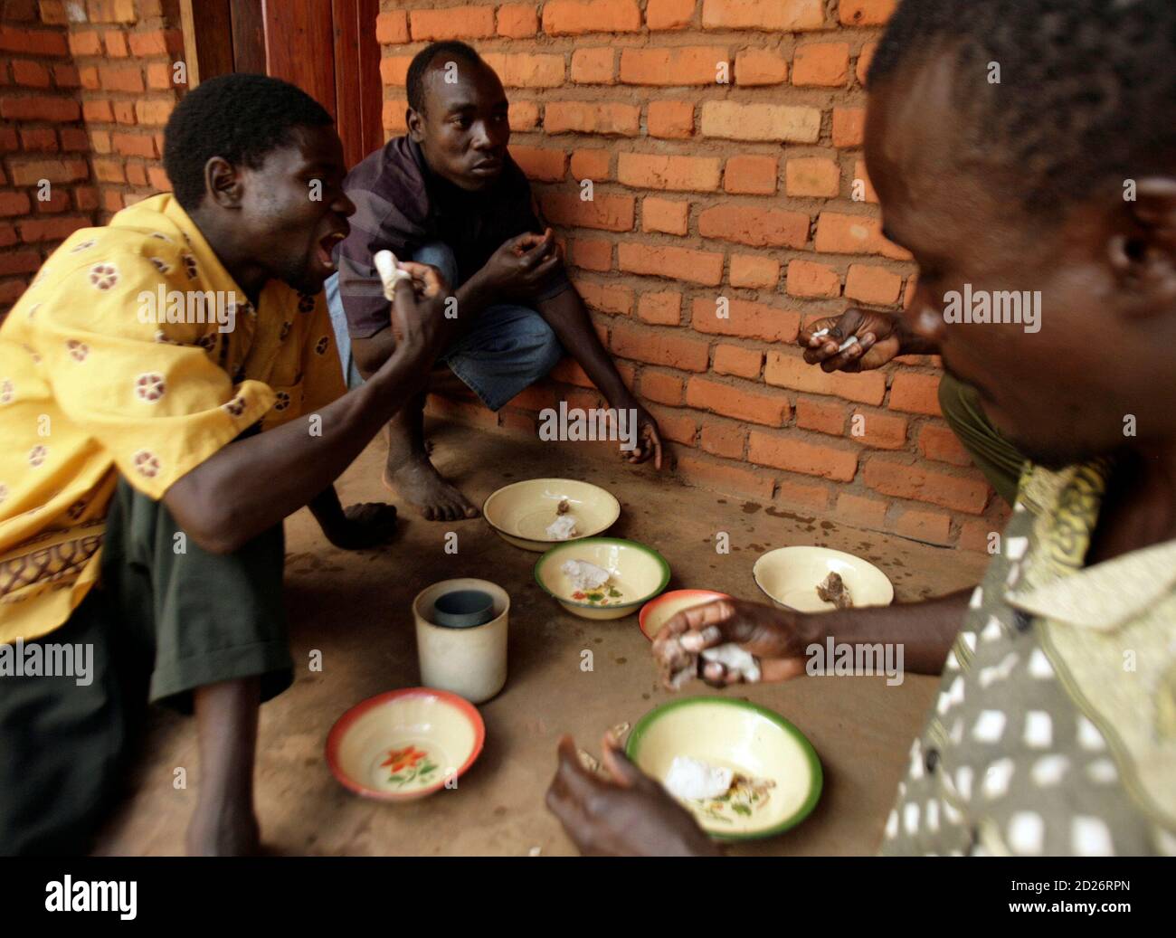 Yohane Banda (C), David Banda's father, shares a meal with his cousins at  his home in Lipunga village about 170 km (106 miles) west of Lilongwe May  11, 2008. U.S. pop star