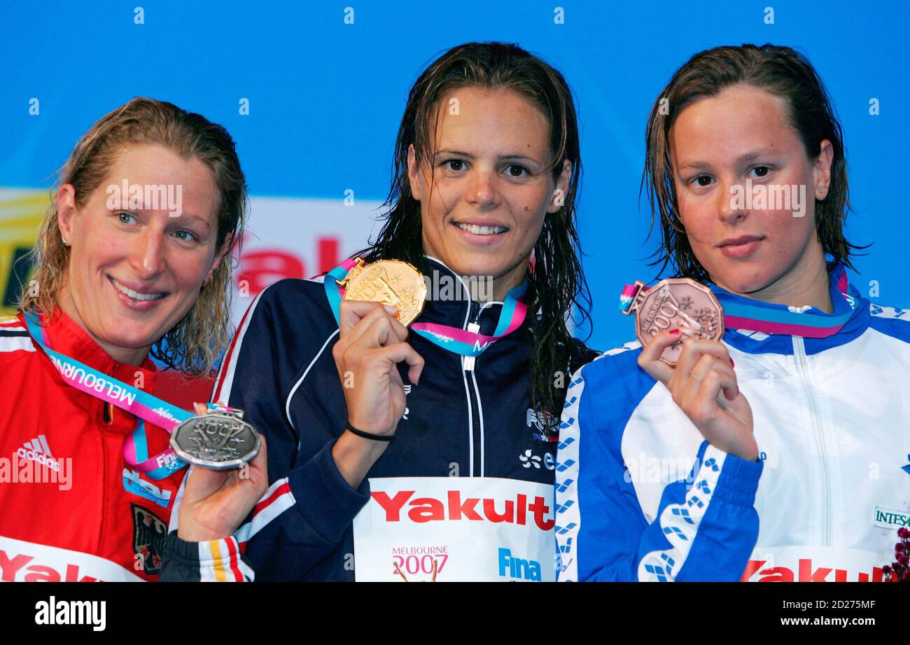 Gold medallist Laure Manaudou (C) of France, silver medallist Annika Lurz  (L) of Germany and bronze-medallist Federica Pellegrini of Italy pose with  their medals during the medal ceremony for the women's 200m