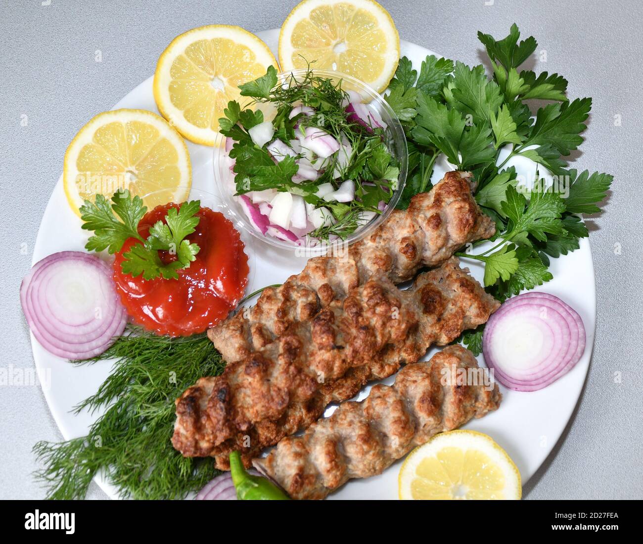 Lula kebab in Mediterranean cuisine with fresh herbs Stock Photo