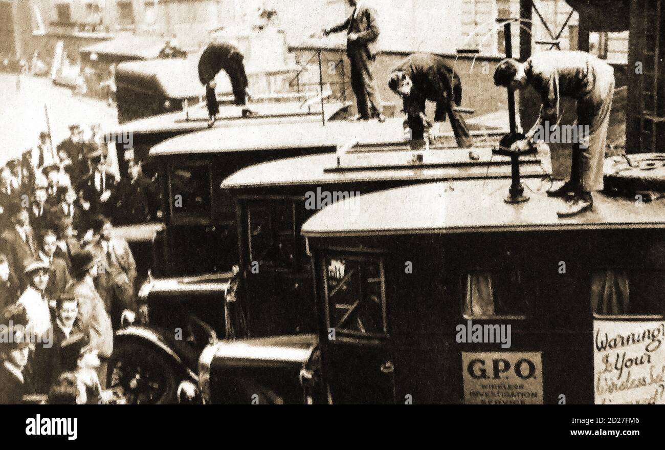 Magazine photograph from 1931 - This year saw the introduction of Detector vans to find 'Pirates' , (those listening  to radio programmes without having bought a licence). Licences cost 10/- (ten shillings) a year and could be bought at Post offices.The first broadcasting receiving licence was introduced in the UK in 1904 to cover the reception of radio broadcasts and was paid annually Stock Photo