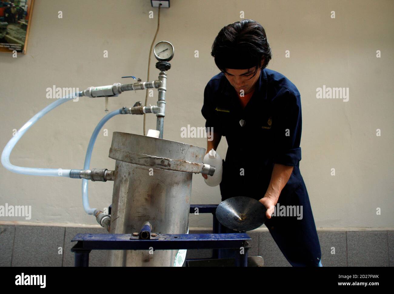 A worker receives gold pieces from a machine invented by Peruvian engineer  Carlos Villachica after the separation process at a laboratory in Lima  April 16, 2010. Villachica says he has come up