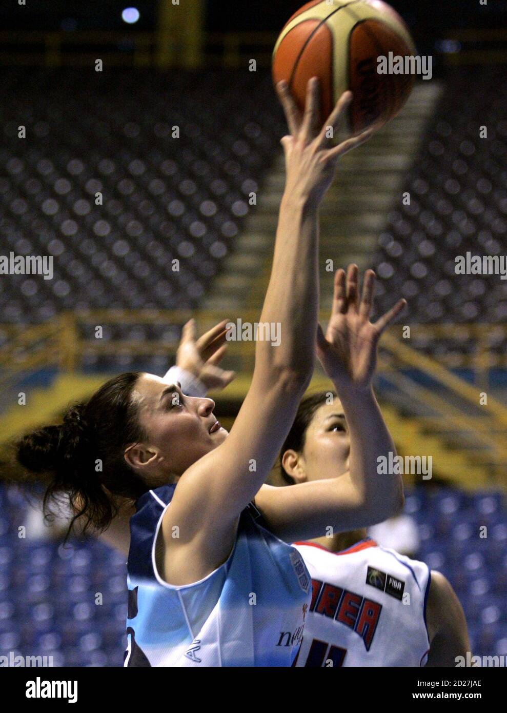 South Korea's Kwe Ryong Kim (R) tries to stop Argentina's Gisela Vega during their women's World Championship basketball game in Sao Paulo September 14, 2006. REUTERS/Paulo Whitaker (BRAZIL) Stock Photo
