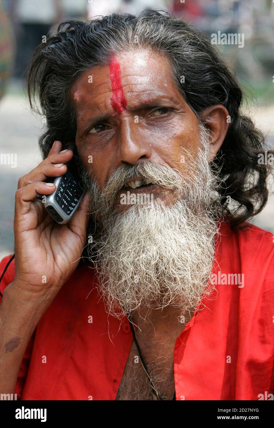 A Hindu holy man speaks on a mobile phone in the northeastern Indian city  of Siliguri August 24, 2007. Nokia, the world's top cellphone maker said on  Thursday India overtook the United