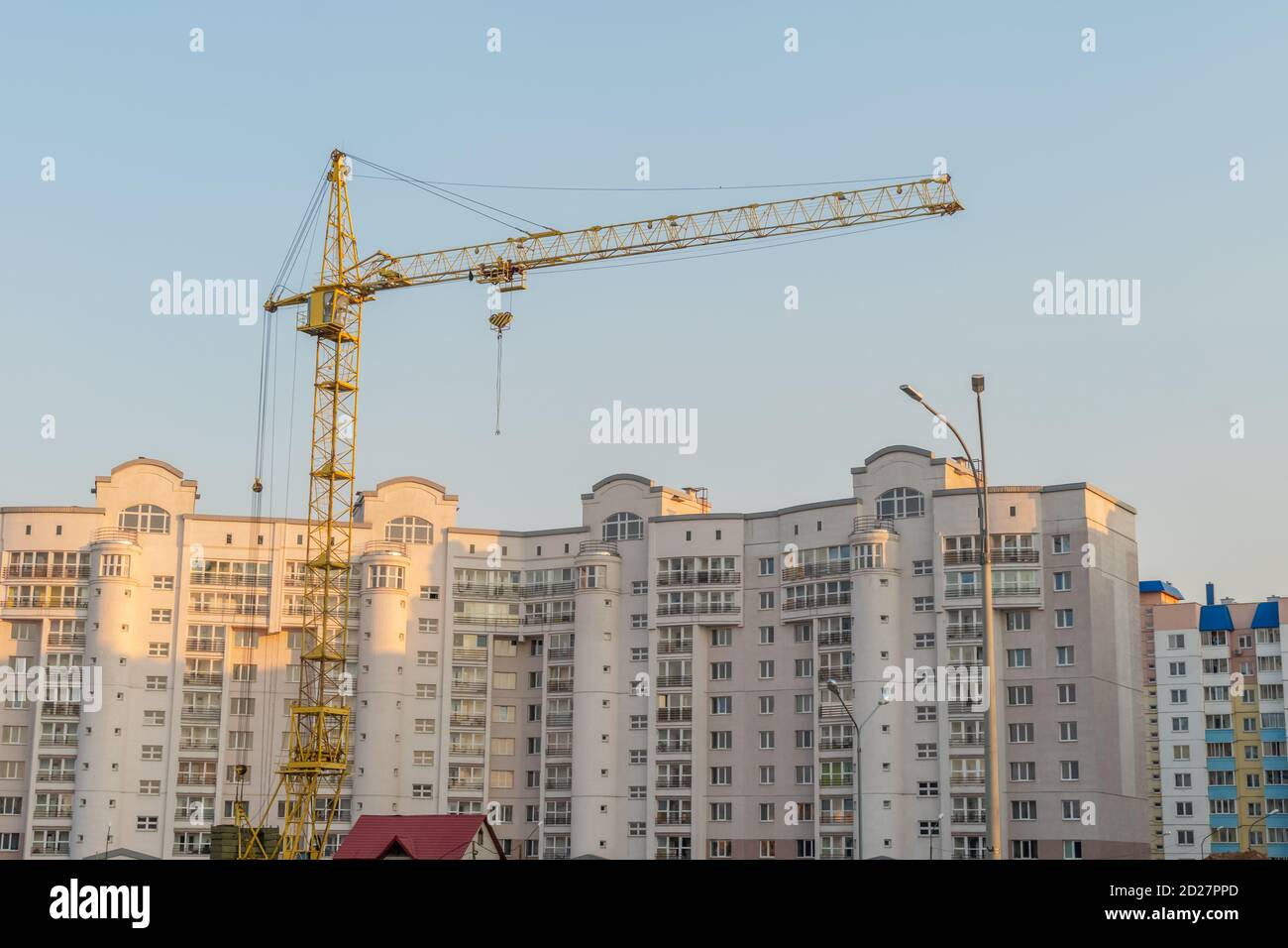 yellow tower crane and the construction of a multi-storey building ...