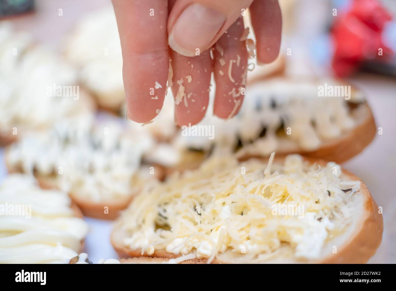 woman's hand close up sprinkles grated cheese sandwich Stock Photo Alamy