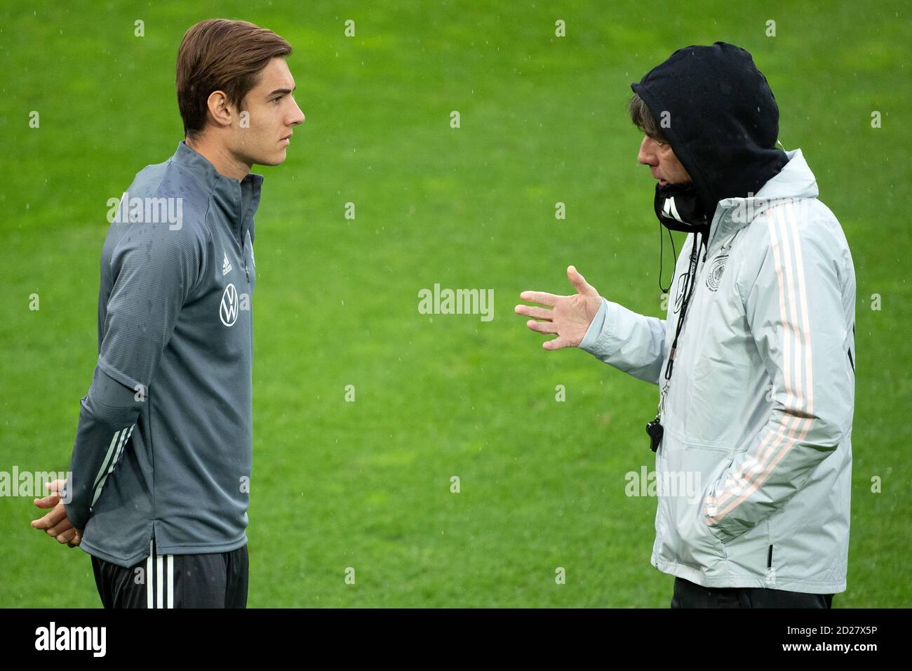Cologne, Germany. 06th Oct, 2020. Football: national team, the day before the international test match against Turkey. National coach Joachim Löw (r) talks to Florian Neuhaus during the training of the national team in the RheinEnergie stadium. Credit: Federico Gambarini/dpa - IMPORTANT NOTE: In accordance with the regulations of the DFL Deutsche Fußball Liga and the DFB Deutscher Fußball-Bund, it is prohibited to exploit or have exploited in the stadium and/or from the game taken photographs in the form of sequence images and/or video-like photo series./dpa/Alamy Live News Stock Photo