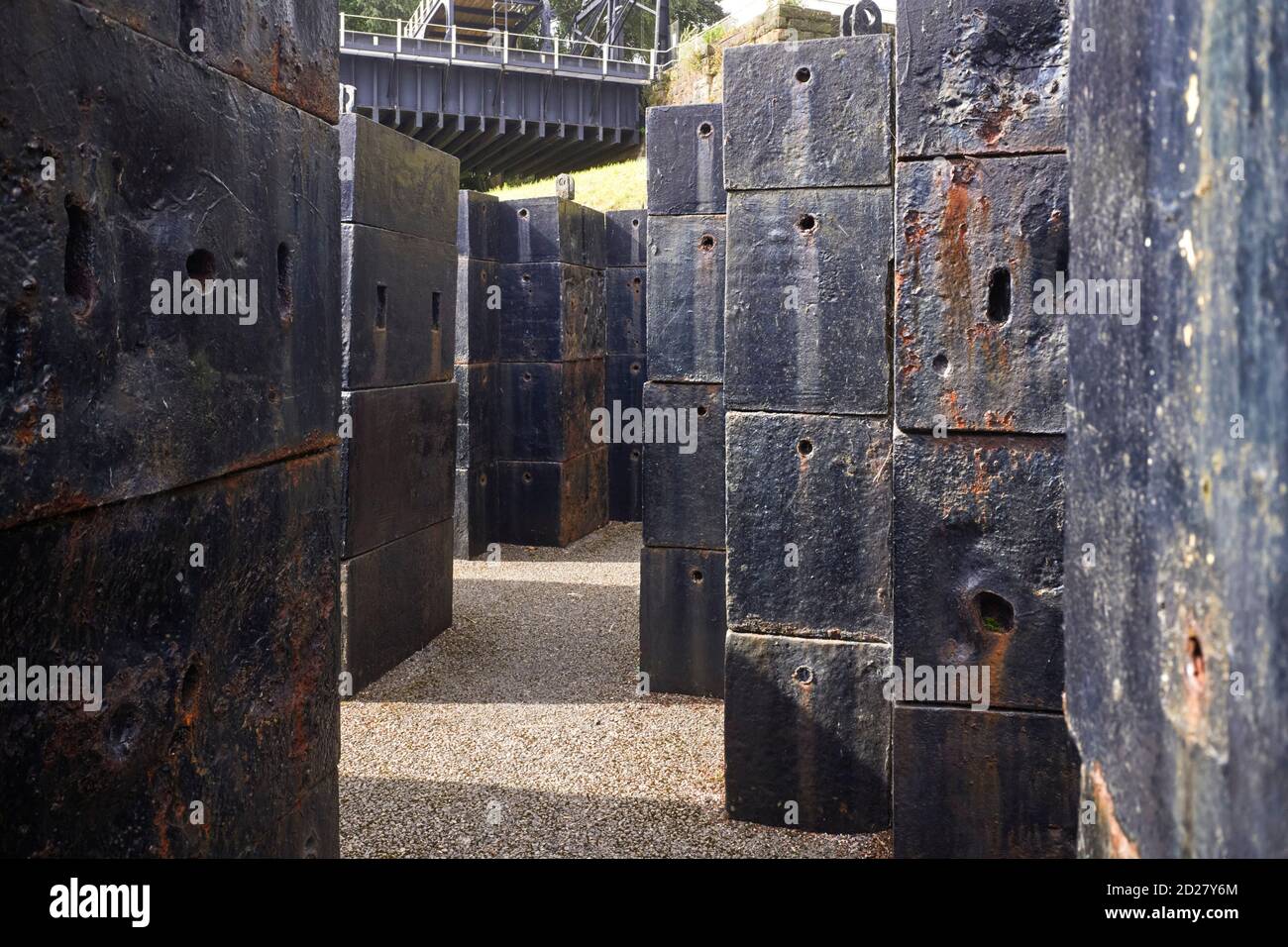 Heavy iron block counterweights not currently used at the Anderton boat life on the Trent and Mersey canal Stock Photo