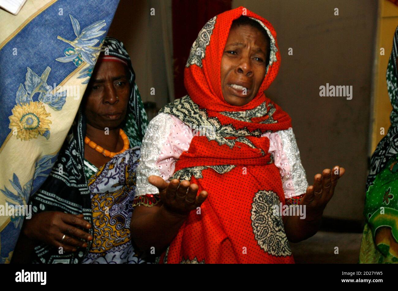 Unidentified auntie to 14-year-old Franco-Comoran girl Bahia Bakari, the sole survivor of the Yemenia Airbus A310-300 plane crash, cries inside their house in Nioumazadha village in Bambao area, about 15 km (9 miles) south of Comoros' capital Moroni, July 3, 2009. The sole survivor of the Yemeni jet that plunged into the Indian Ocean off the Comoros islands was reunited with her father in France, but rescuers said hopes of another miracle find were all but over. REUTERS/Thomas Mukoya (COMOROS DISASTER TRANSPORT) Stock Photo