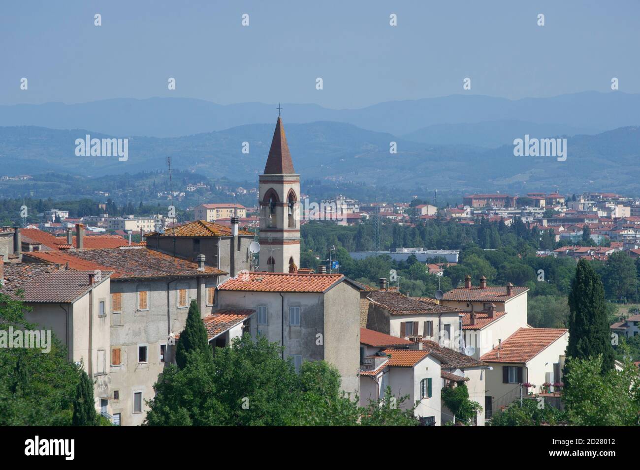 the village and the city with their typical dominant bell towers. Arezzo and its surroundings at dawn Stock Photo