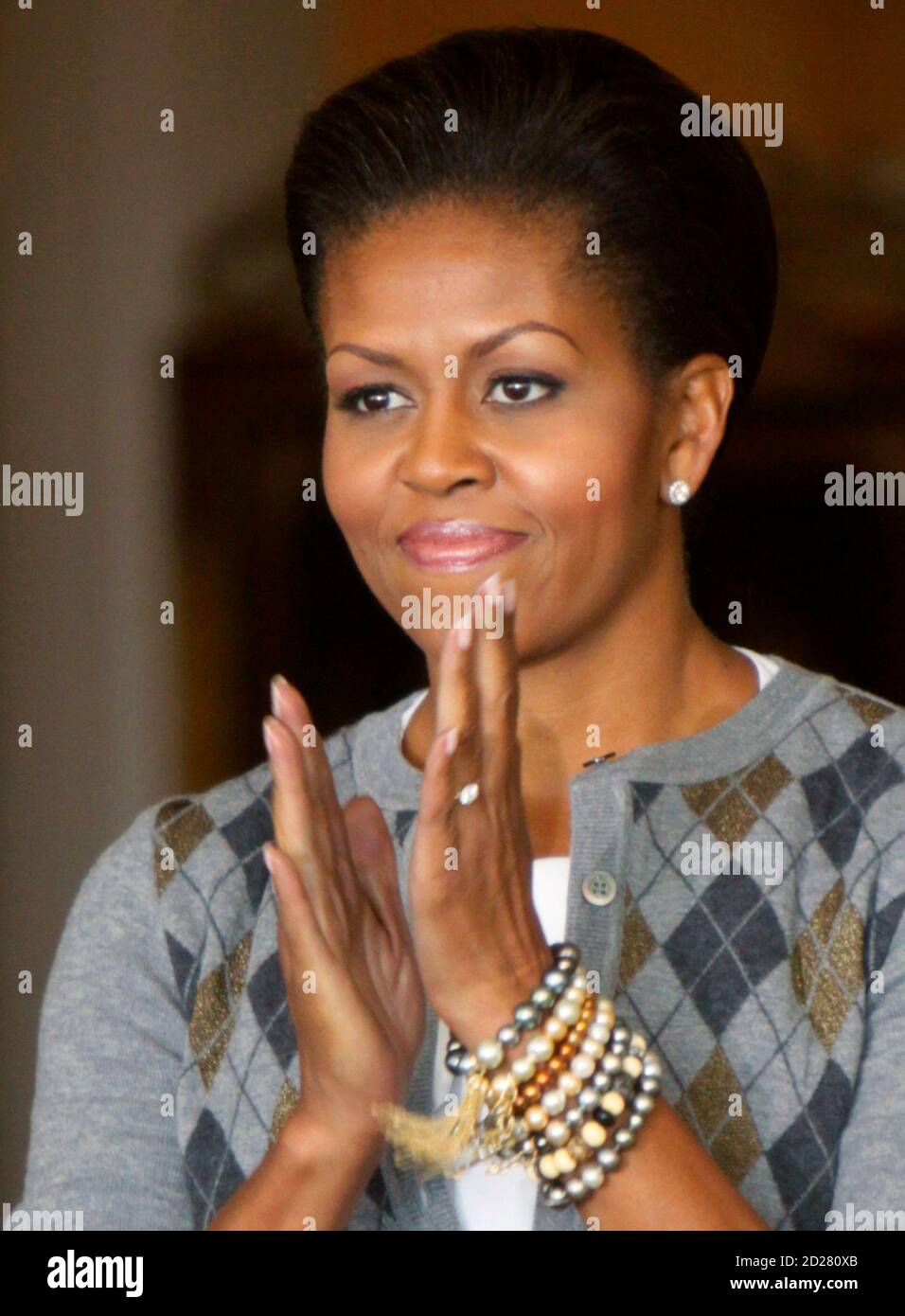 U.S. first lady Michelle Obama applauds before speaking at a Girls Mentoring Luncheon at the Governor's Mansion in Denver, Colorado November 16, 2009. REUTERS/Rick Wilking (UNITED STATES POLITICS EDUCATION) Stock Photo