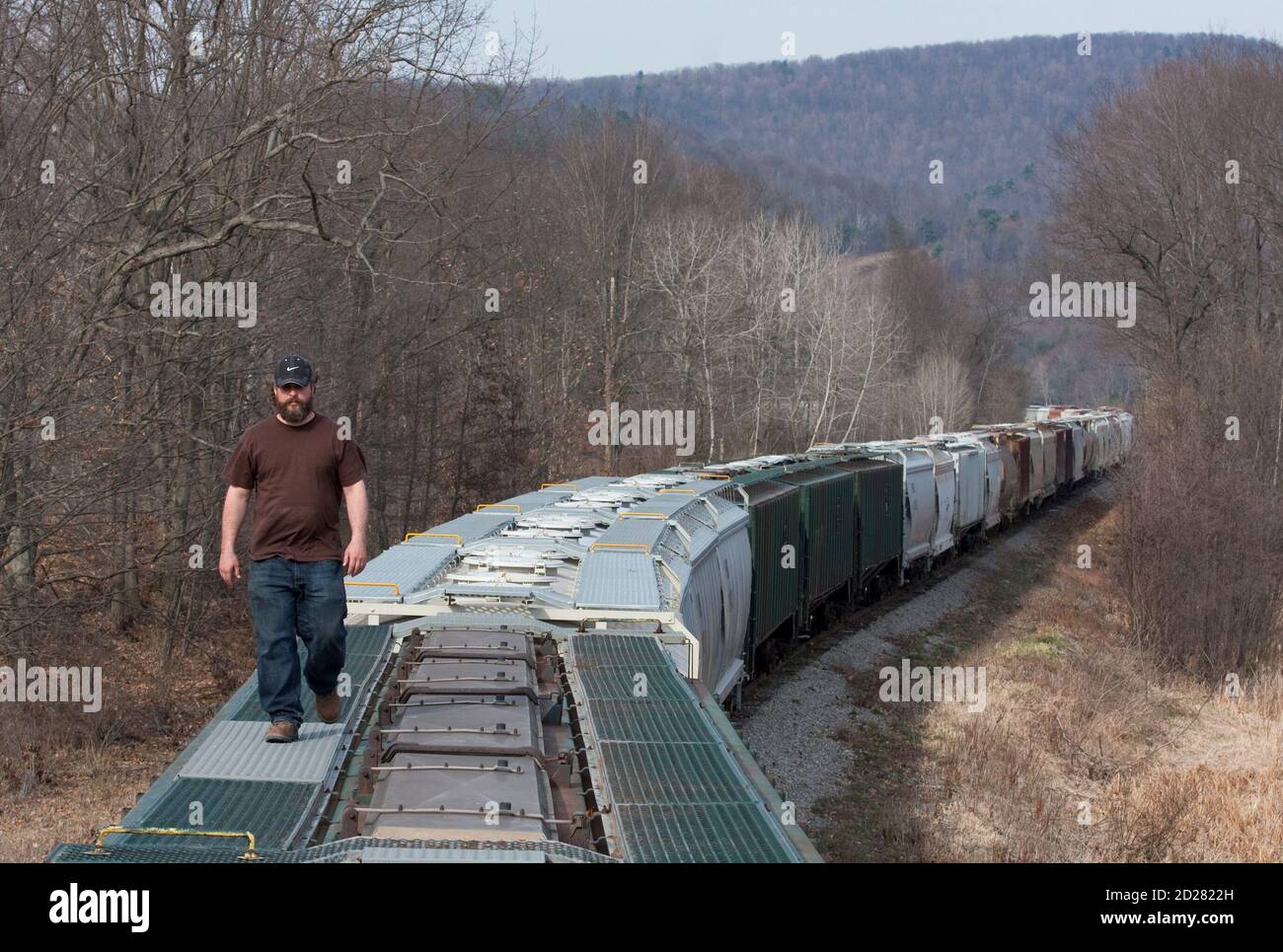 Chief Operating Officer of Wellsboro & Corning Railroad Bill Myles examines the end of a 75-car train carrying sand that his company transloads for energy companies drilling natural gas wells in Wellsboro, Pennsylvania April 3, 2010. The booming natural gas industry, which uses the sand in hydraulic fracturing operations, has led to an economic revival of the businesses and towns that support it. Picture taken April 3, 2010. REUTERS/Adam Fenster  (UNITED STATES - Tags: ENERGY TRANSPORT BUSINESS) Stock Photo