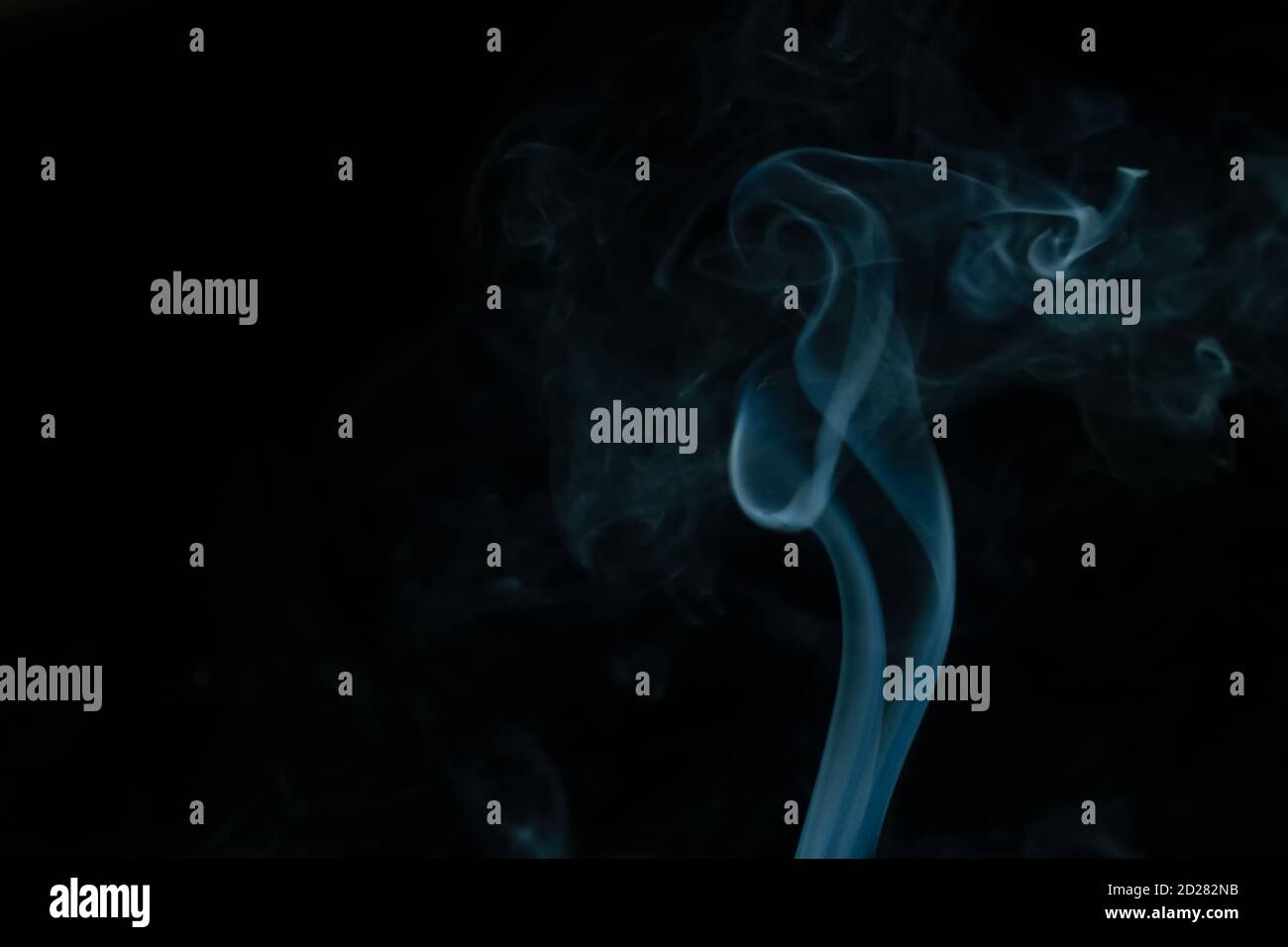 Beautiful abstract blue smoke with copy space on black background ...