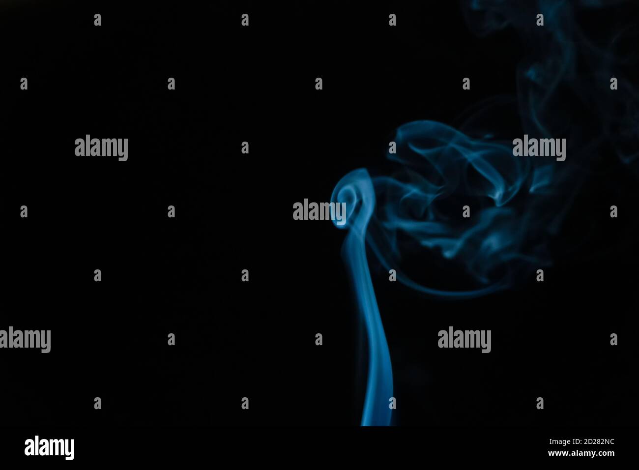 Beautiful abstract blue smoke with copy space on black background ...