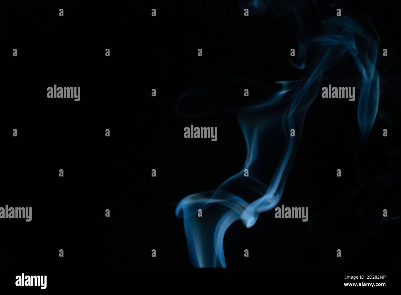 Beautiful abstract blue smoke with copy space on black background ...