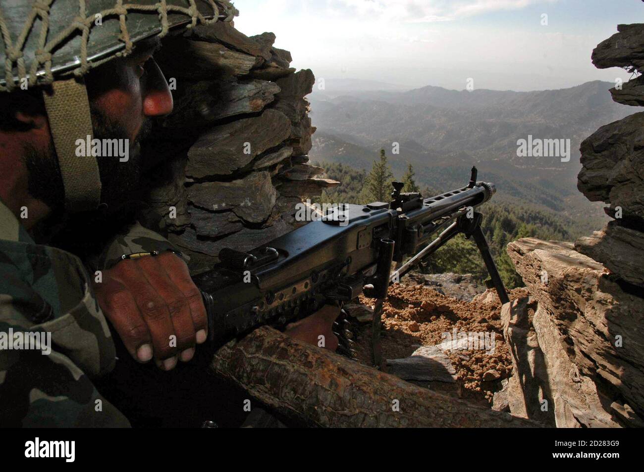 Pakistani army soldier sits in bunker as he monitors AfghanPakistan