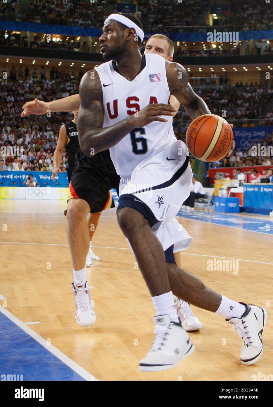 Lebron James of the . (R) drives to the basket past Dirk Nowitzki of  Germany during their men's Group B basketball game at the Beijing 2008  Olympic Games August 18, 2008. REUTERS/Lucy