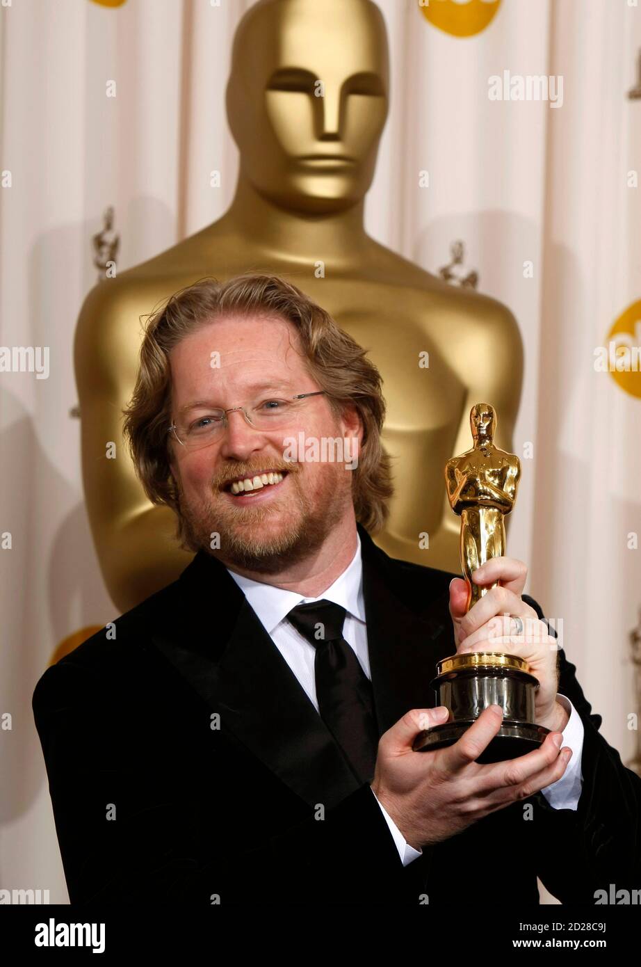 Andrew Stanton holds his Oscar for best animated feature, for the film Andrew Stanton holds his Oscar for best animated feature, for the film